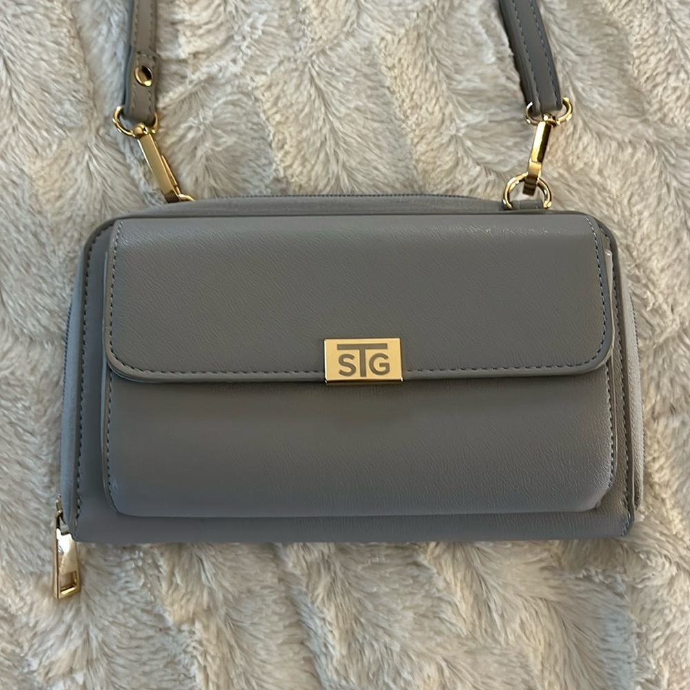 Gray STG crossbody purse in good preowned condition. Light gray